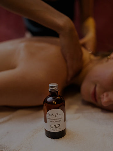 Bouteille en verre brun avec étiquette blanche, huile de massage de marque "enez"